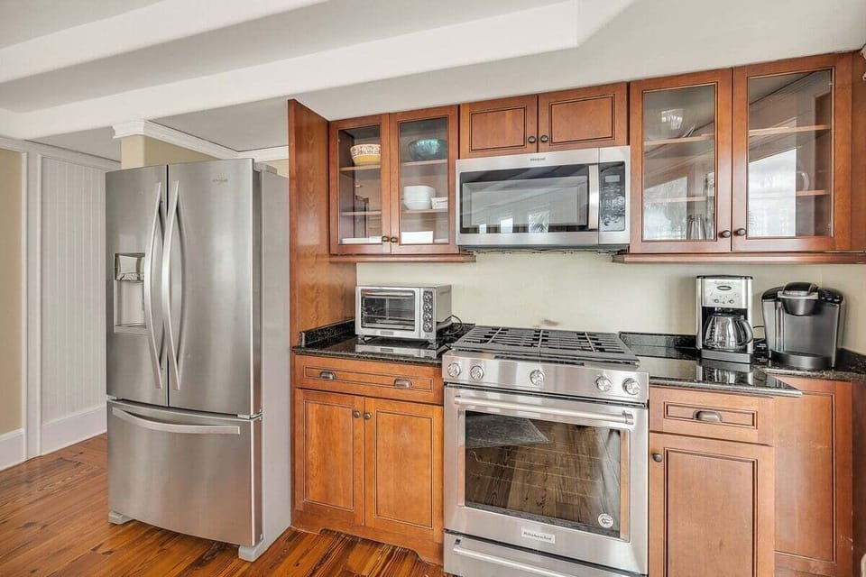 Kitchen with wood cabinets, gas range, and stainless refrigerator