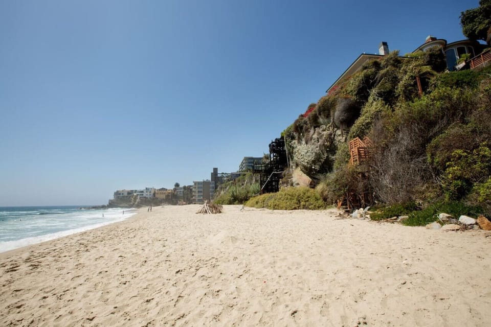 Sandy beach stretching along dramatic cliffs, perfect for long seaside walks