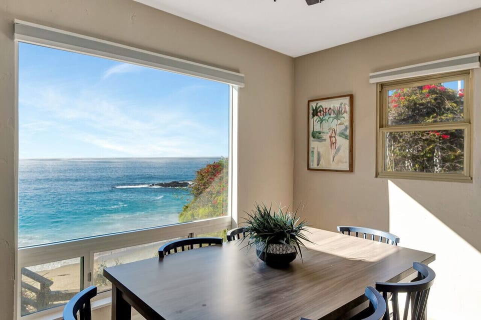 Dine by a picture window framing sweeping ocean views