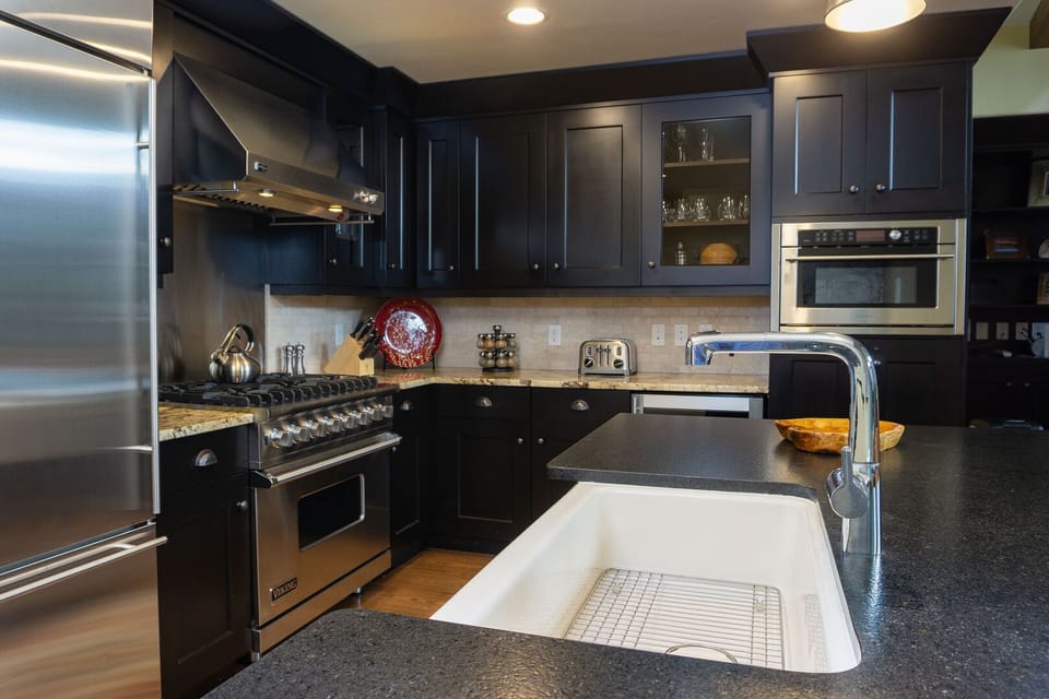 Large sink, plenty of counter space, and beverage refrigerator add to the appeal of the kitchen.