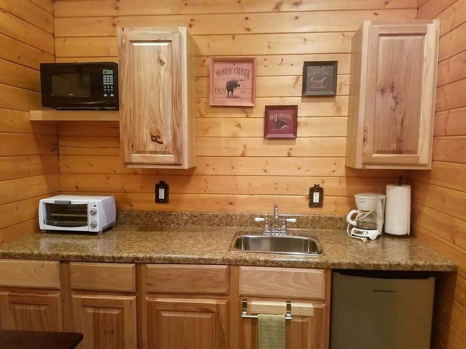 Kitchen with microwave, toaster over and mini fridge