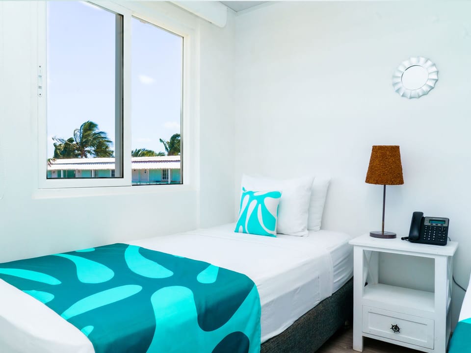 Triple Room, Pool View | Premium bedding, minibar, in-room safe, blackout drapes