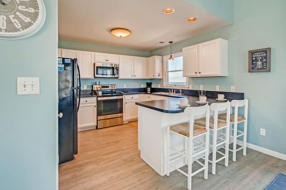 All conveniences are provided in the spacious, well-equipped kitchen right off the great room.