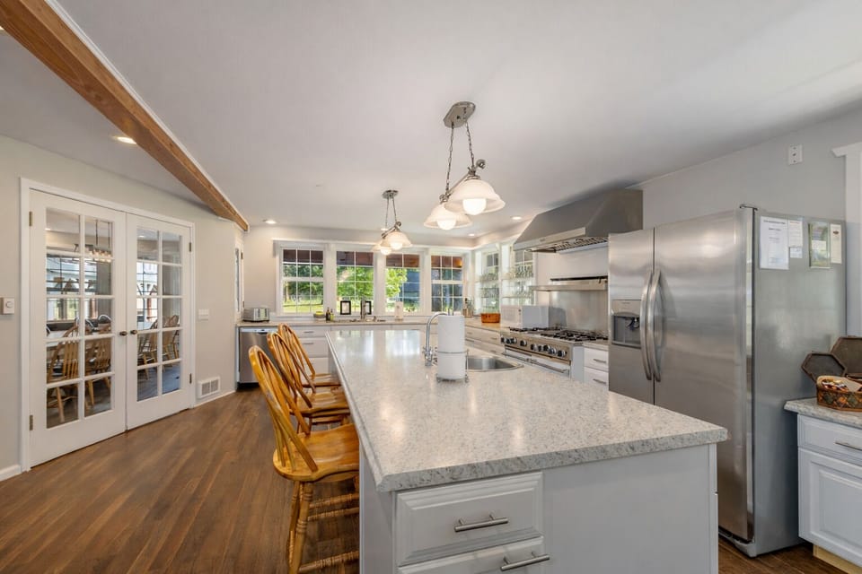 Your spacious chef's kitchen features granite countertops, stainless steel appliances, and a generous island for memorable meal preparations.