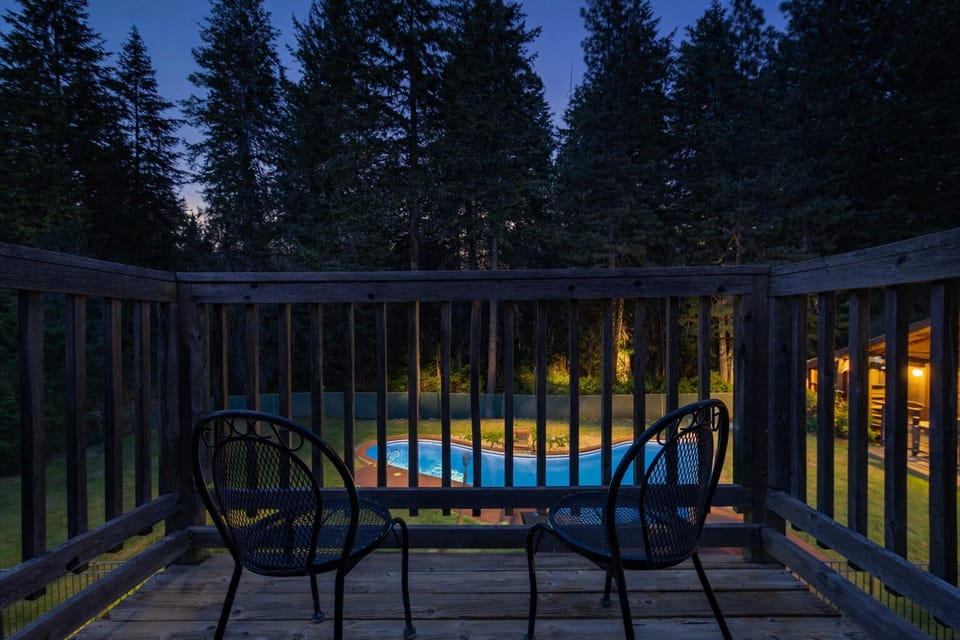 Small private deck off of Bedroom 3 overlooking the hot tub and seasonal pool.