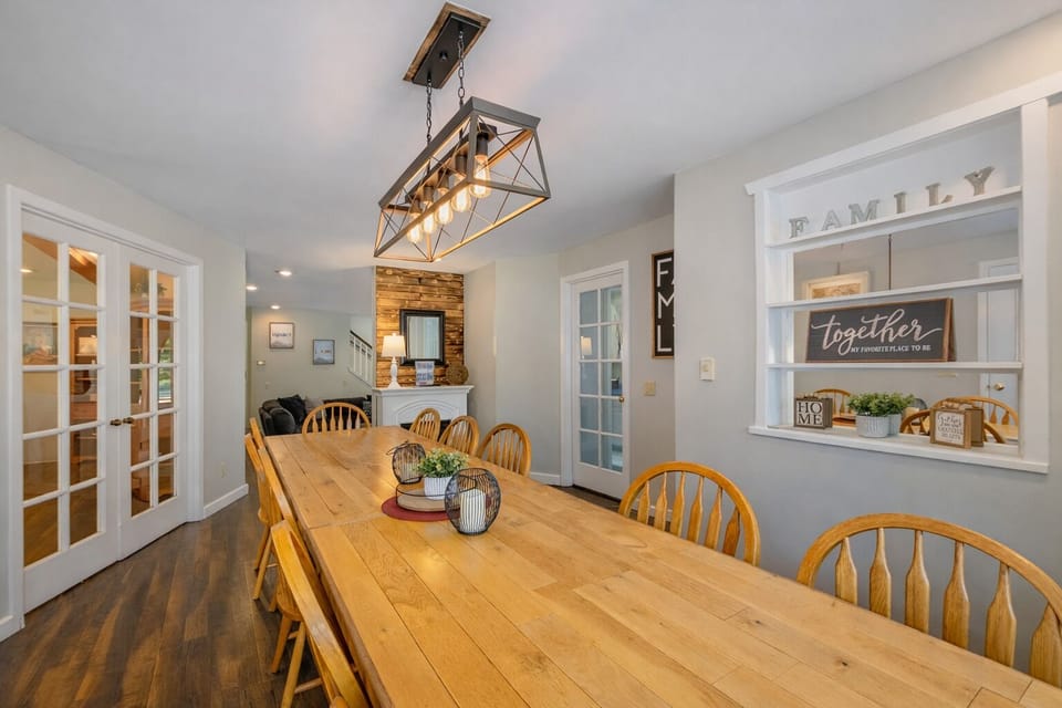 Gather around this stunning farmhouse dining table where your family meals become cherished memories under warm pendant lighting.