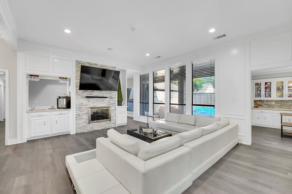 Living room with large 80 inch smart tv and sound bar