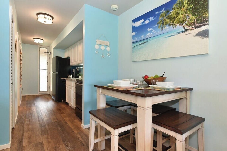 Enjoy intimate meals in this stylish dining area with a tropical-inspired backdrop