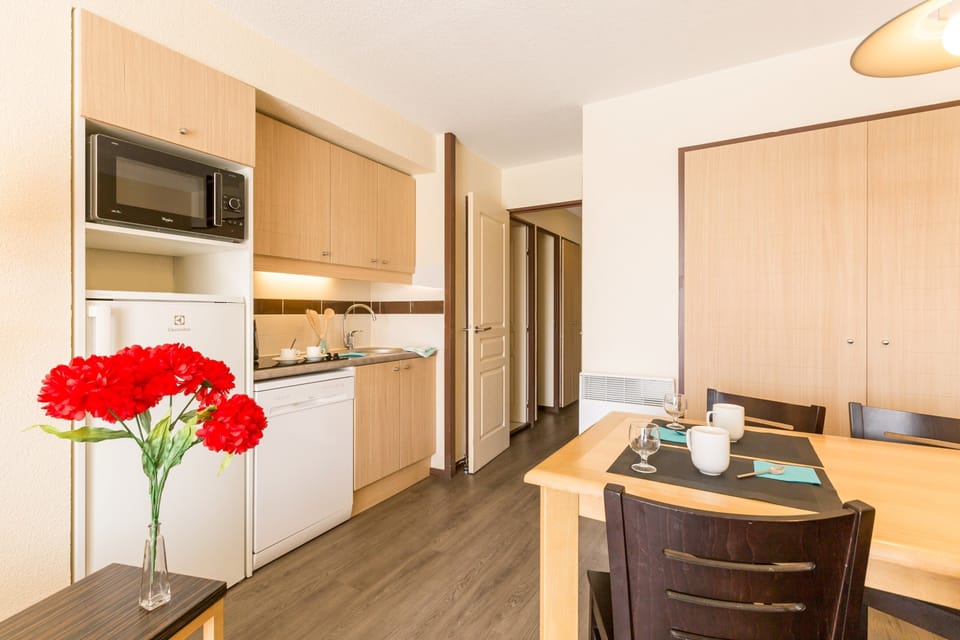 Prepare meals in the kitchenette and enjoy them at the dining table.