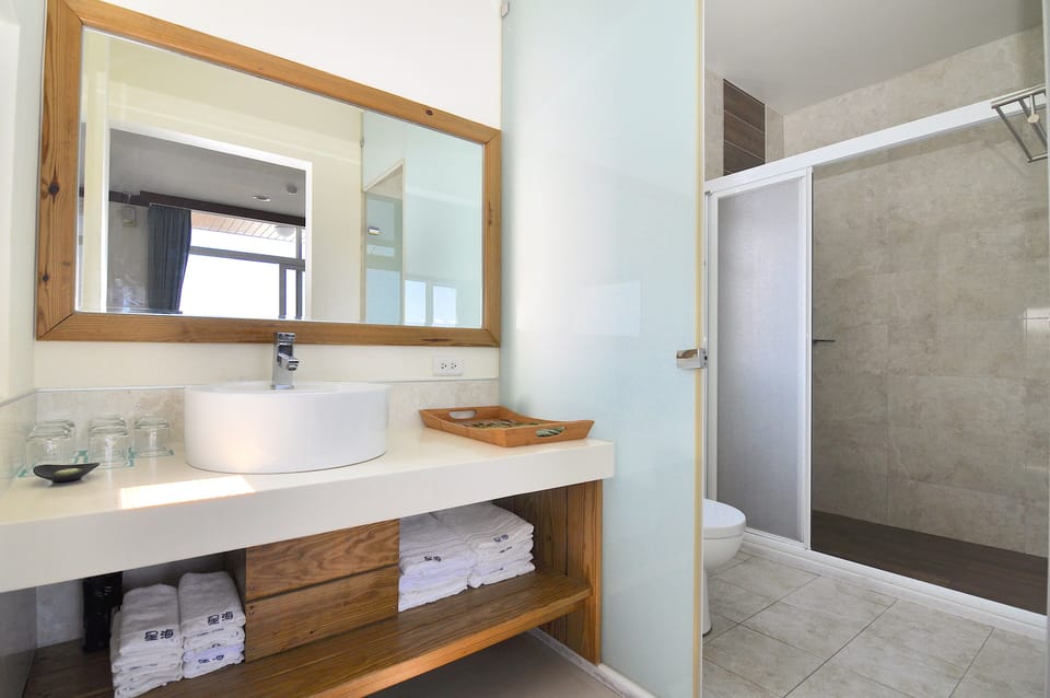 Family Suite | Bathroom | Hair dryer, slippers, towels, shampoo
