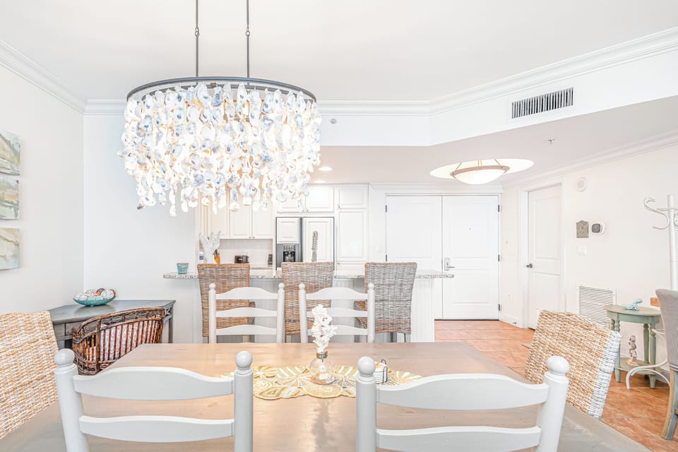 Your elegant dining space features a stunning coastal chandelier and comfortable seating, perfect for memorable meals with family and friends.