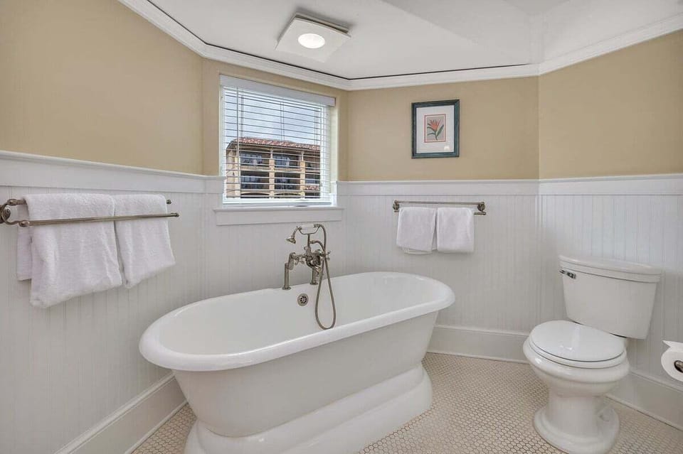 Bathroom with freestanding clawfoot tub and wainscoting