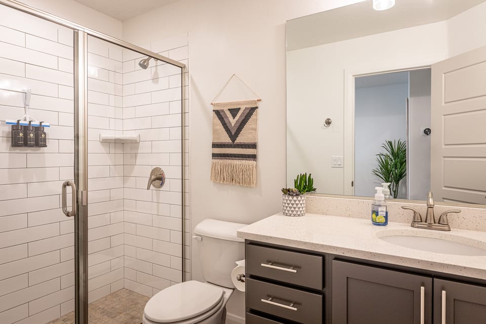 Bathroom 3 - Bathroom 3 includes a large walk-in shower, sink, toilet, and vanity.
