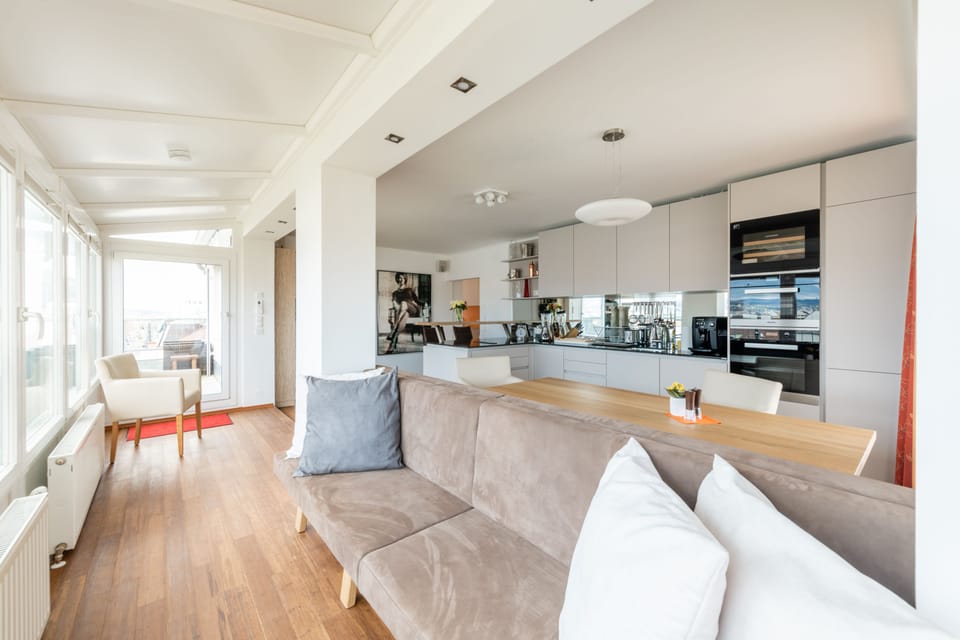 Panoramic Penthouse, 2 Bedrooms, Patio, City View | Living area | Flat-screen TV, heated floors