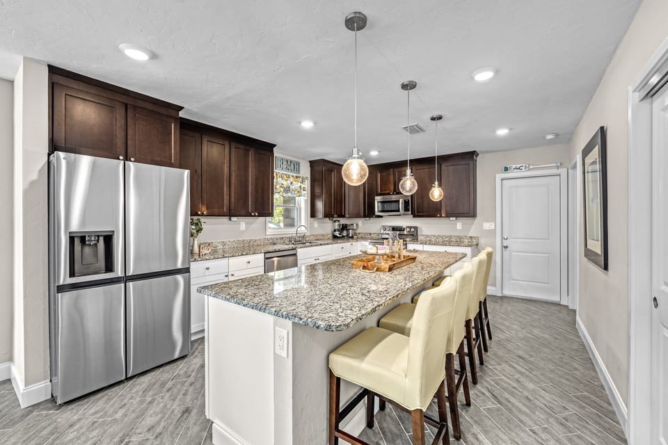 The kitchen island doubles as a breakfast bar—perfect for quick bites or evening chats.