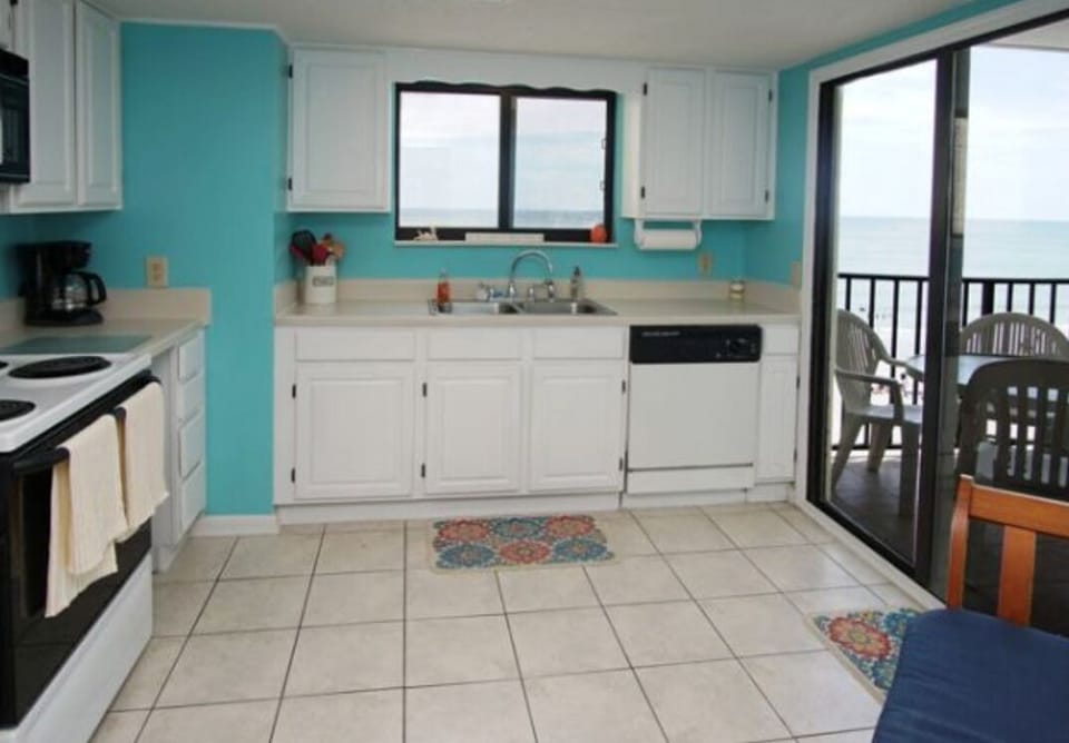Kitchen with balcony access and ocean views over the sink!