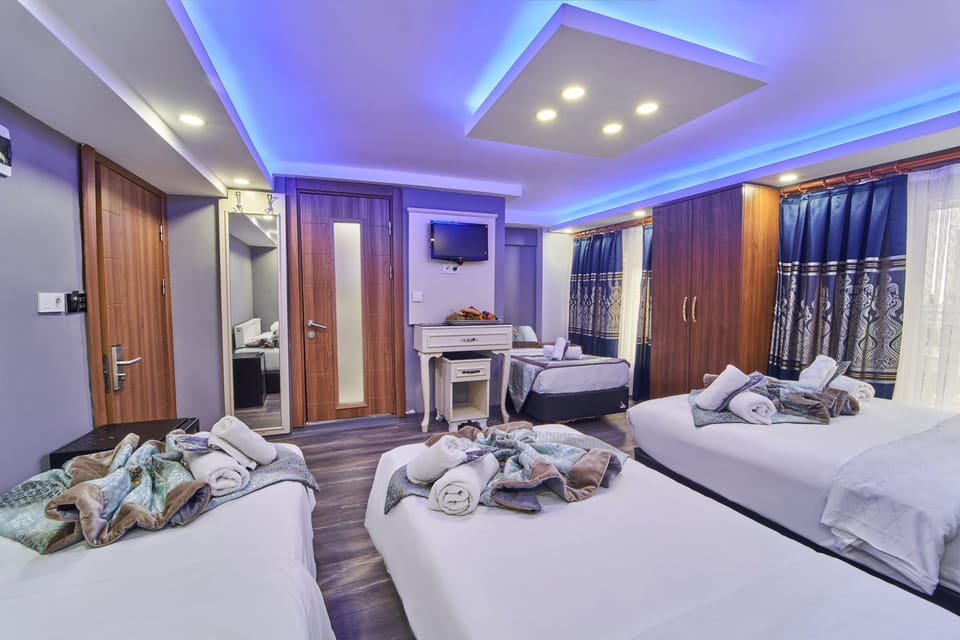 Standard Quadruple Room, Multiple Beds, City View | Minibar, in-room safe, desk, laptop workspace