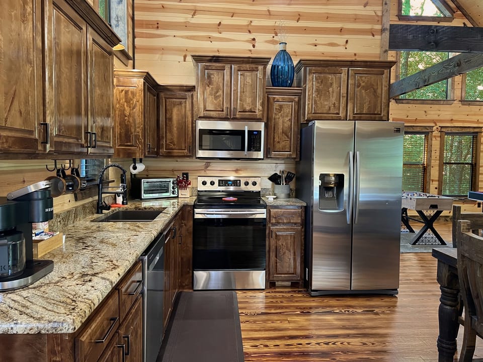 High end appliances and stocked cabinets with everything you need to cook meals.