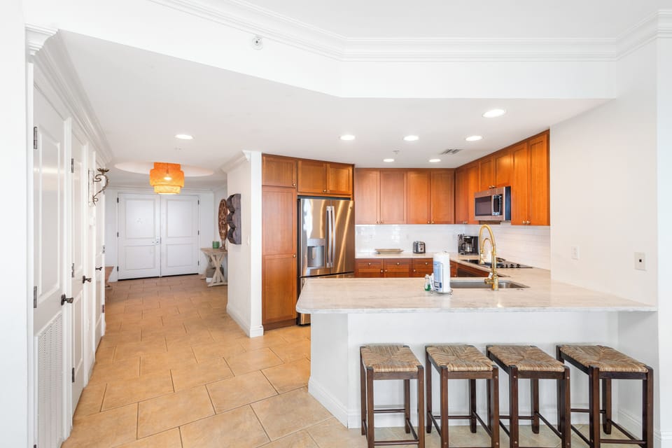 Your fully equipped kitchen awaits with sleek granite counters, stainless steel appliances, and a breakfast bar perfect for morning coffee or casual meals together.
