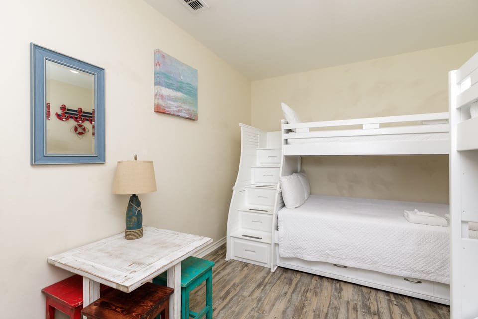 Drift off to sleep in your cozy bunk bed, where nautical touches and soft linens create the perfect retreat for restful nights.