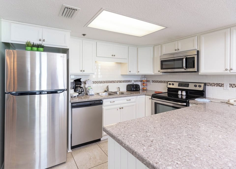 Cook and gather in this stylish kitchen, featuring stainless appliances and ample counter space for meal preparation