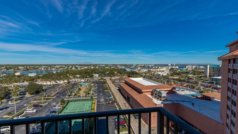 Expansive views from the master balcony, with a vibrant landscape of greenery and nearby amenities below