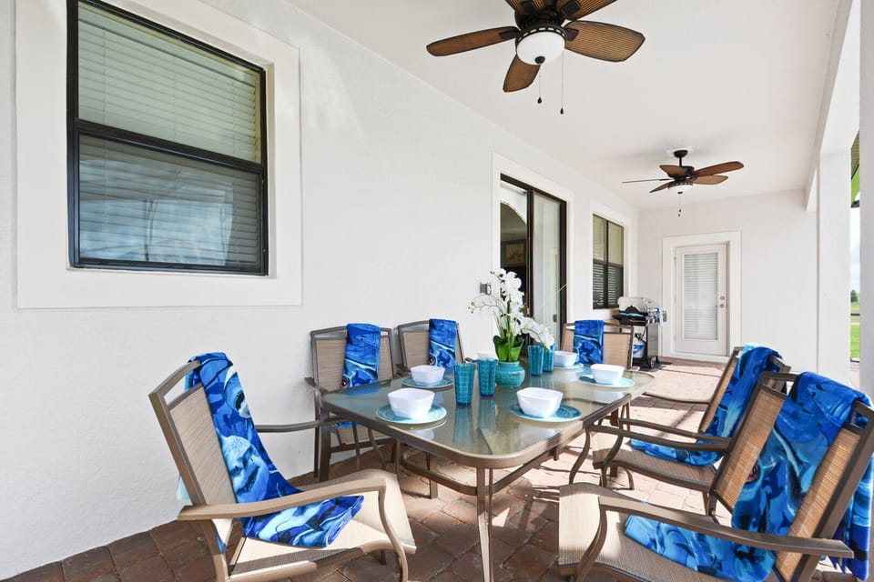 sitting area with grill and pool beside vacation home