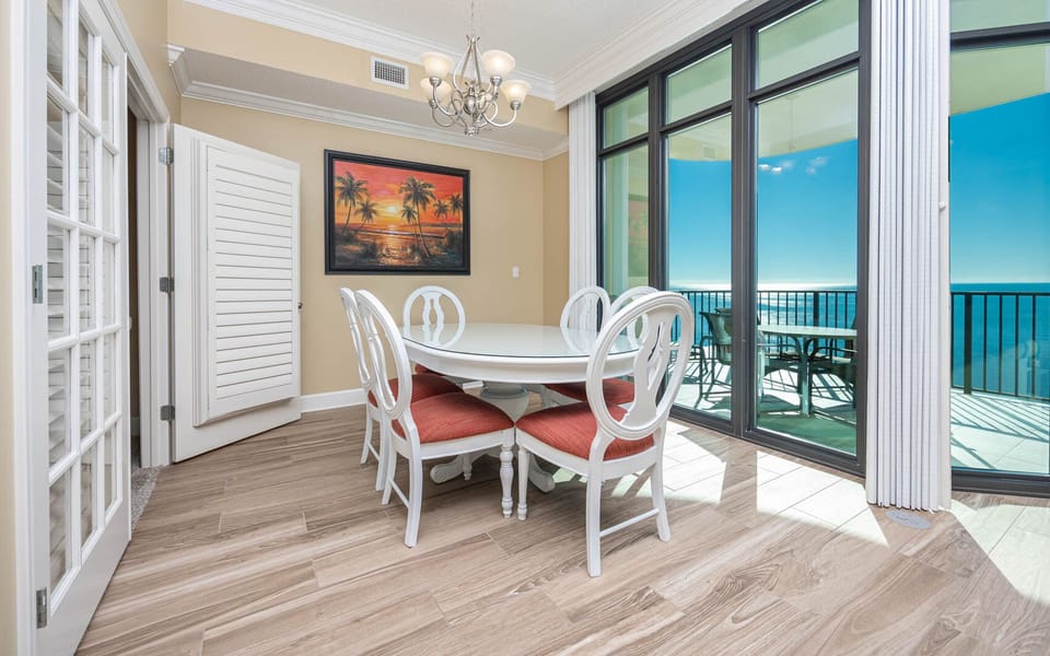 Gather around the charming dining table, enjoying laughter and delightful views of the coast