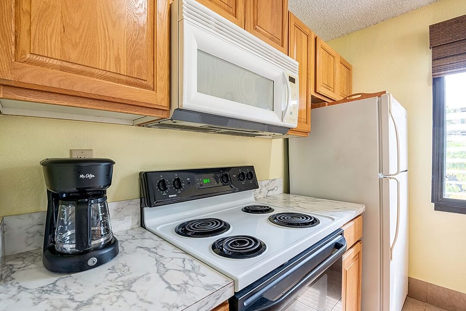 This full-size kitchen includes everything you need — appliances, cookware, and dishes — ideal for quick meals or full dinners.