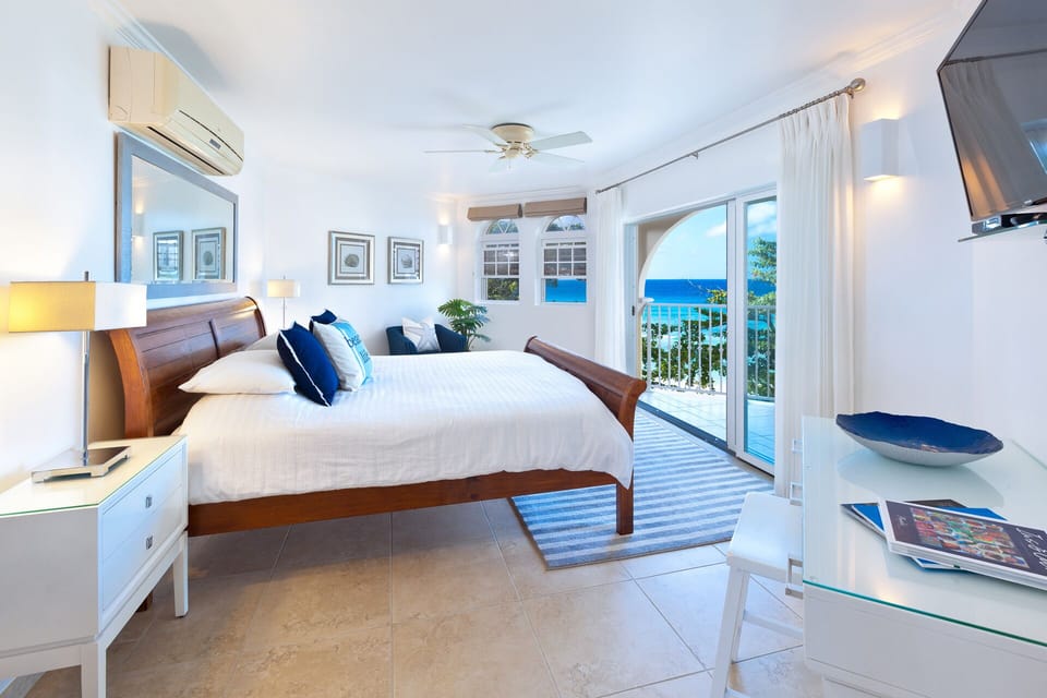 Sapphire Beach 307 - The master king bedroom has AC, access to the patio, a TV and en suite