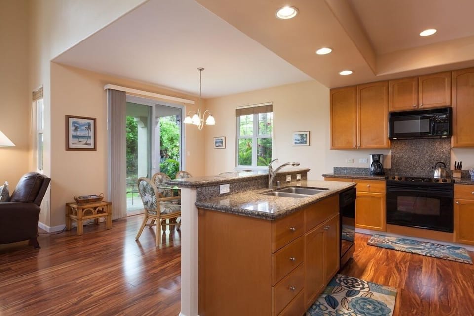 Kitchen island with dishwasher, granite countertops.