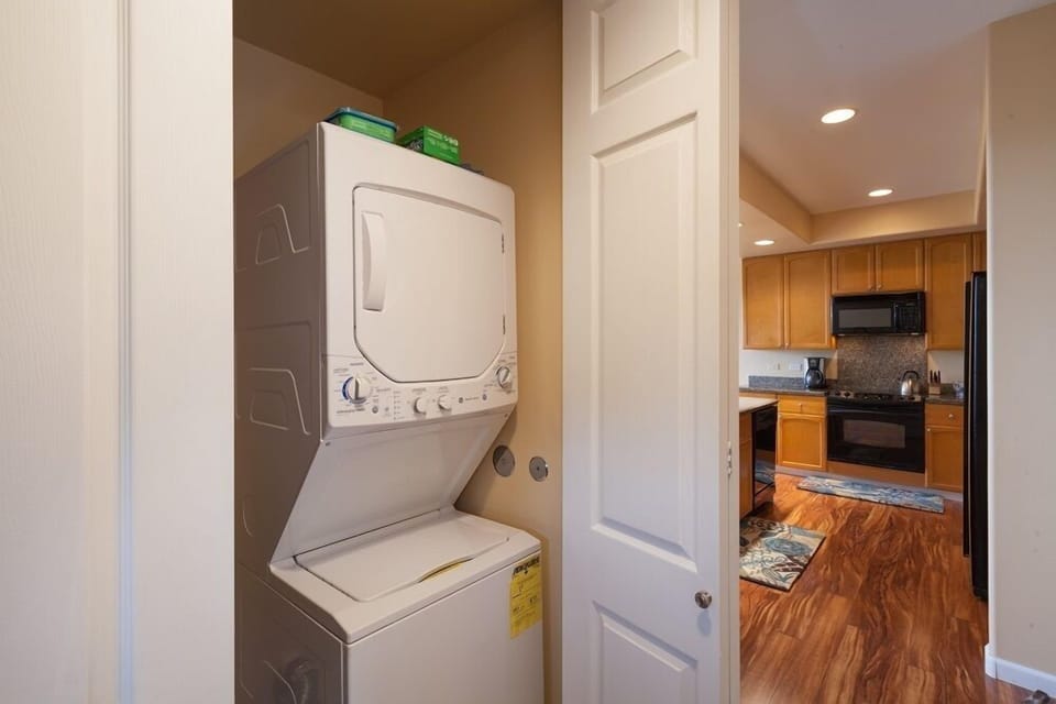Laundry closet with stacked washer and dryer for convenience.