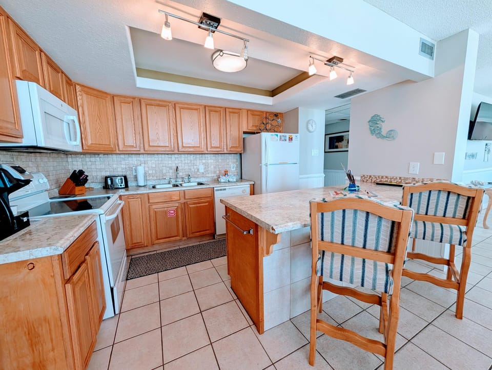 Bright, spacious kitchen with cozy breakfast bar seating