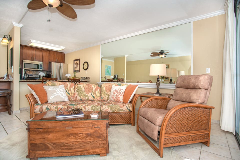 Living room with queen sofa bed and recliner. Bright living area with queen sleeper sofa, comfortable seating, and direct views over the pool to the ocean.