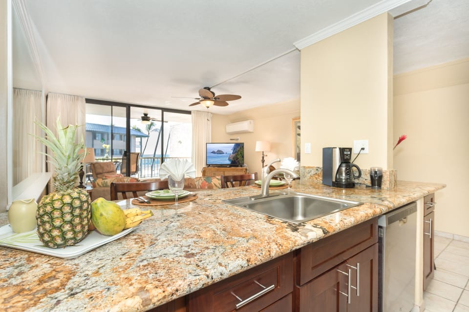 Guests share clean up in this kitchen is a pleasure. Granite countertops, full-size stainless appliances, and everything needed for cooking at home—plus an ocean view right from the kitchen.