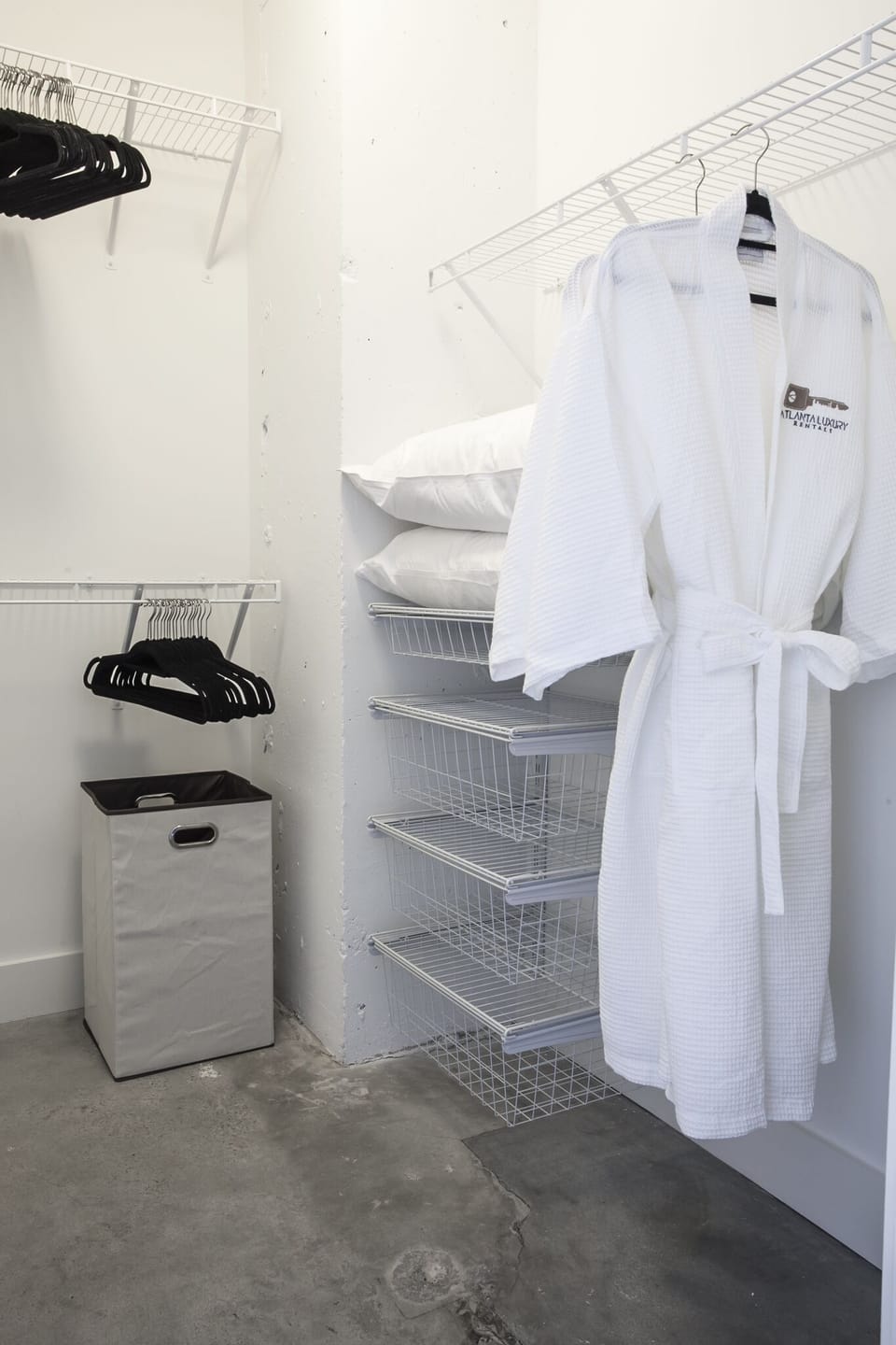 Closet with a robe hanging inside it.