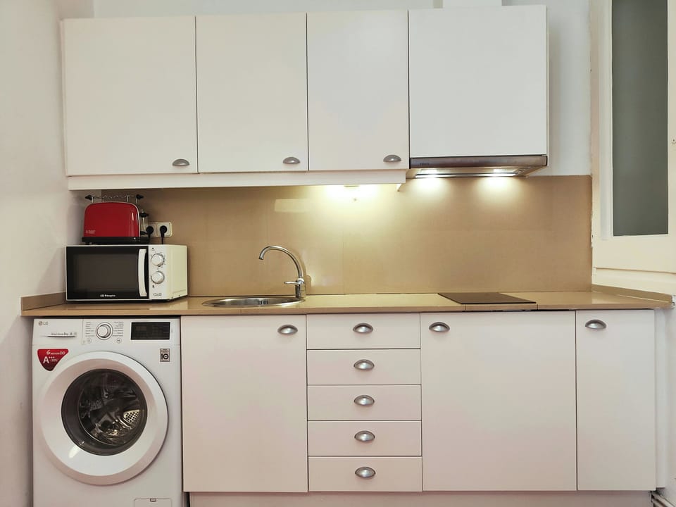 Open kitchen fully equipped and includes a washing machine for added convenience.