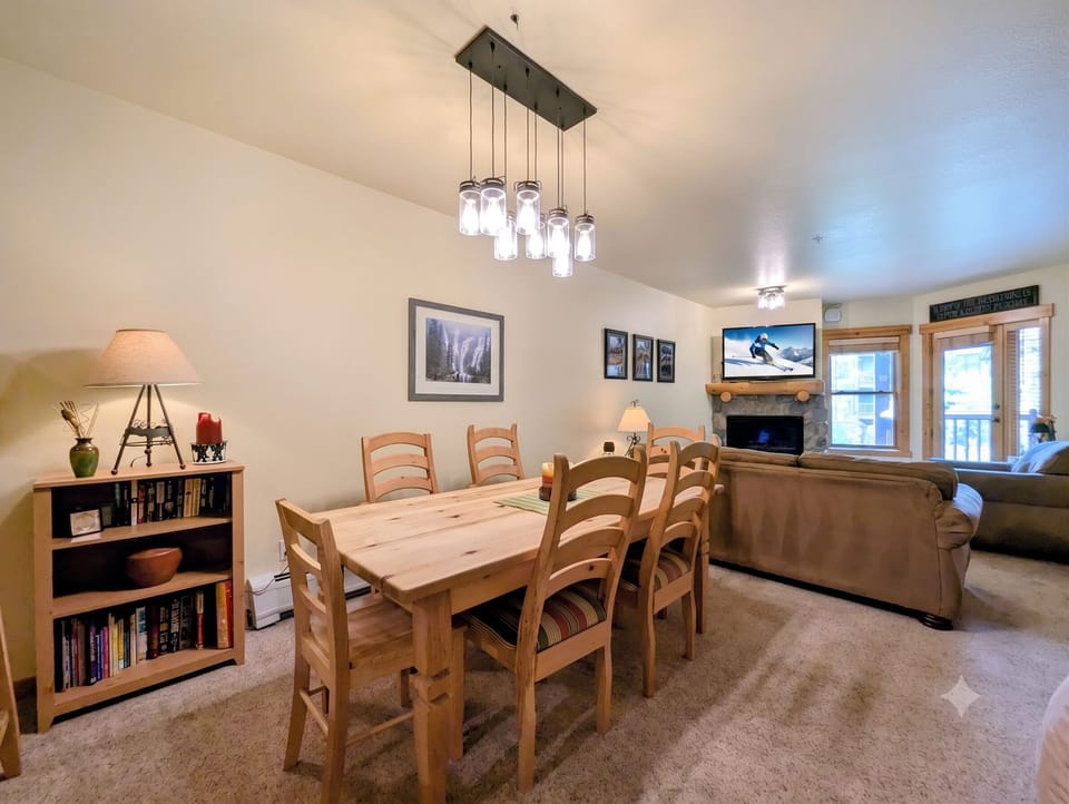 Gather around the handcrafted wooden table for meals and memories, warmed by the fireplace glow and mountain light streaming through your windows. Cozy seating and thoughtful touches create your perfect retreat.