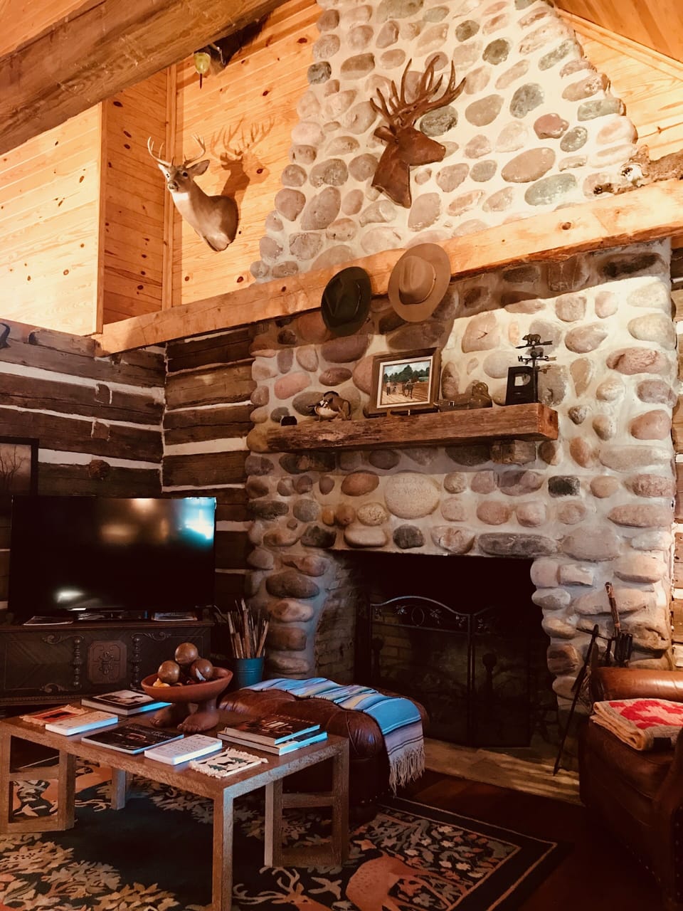Main cabin den with oversized wood burning fireplace