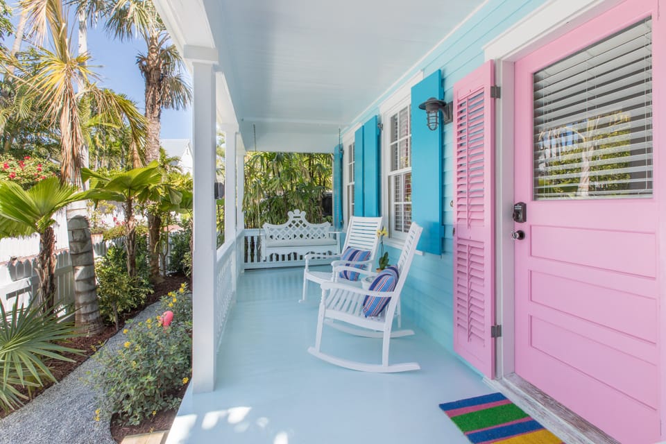 The front porch has a porch swing and two rocking chairs