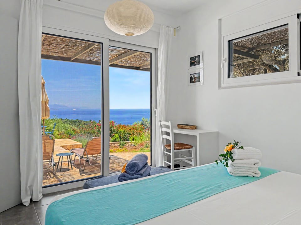Wake up to natural light and soothing sea views in your serene bedroom.