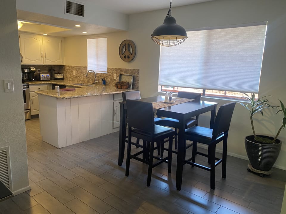 Dedicated dining area with pub height table and chairs and large window