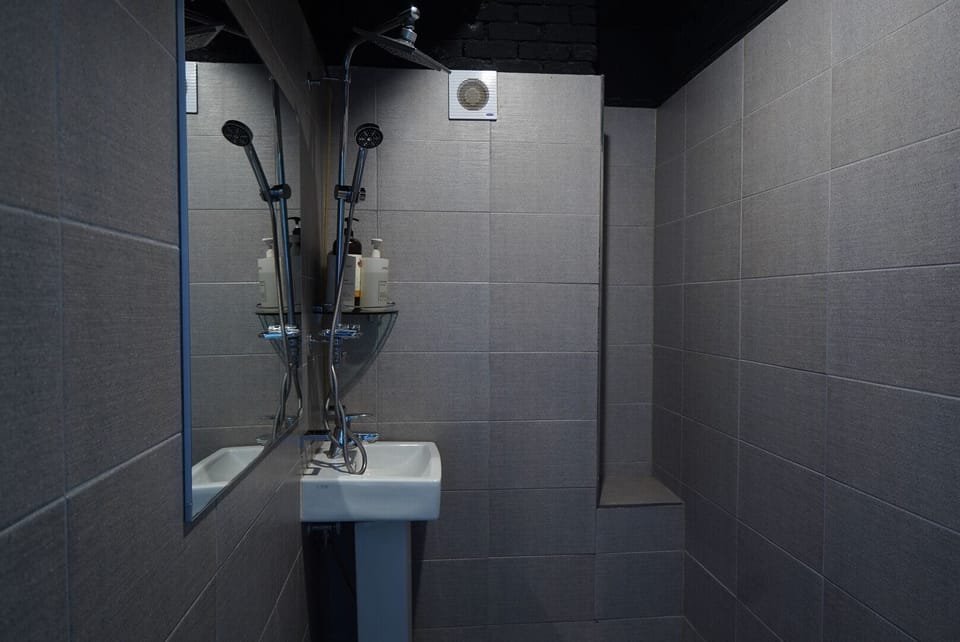 Shower, hair dryer, slippers, towels