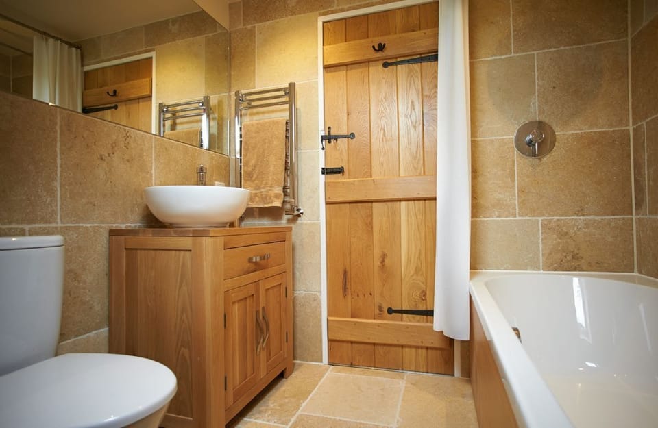 First floor:  En-suite bathroom with shower over bath