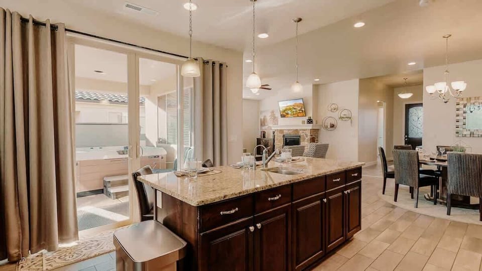 Fully stocked kitchen has a large island with seating for 3, 2 sinks, reverse osmosis drinking water and deluxe appliances