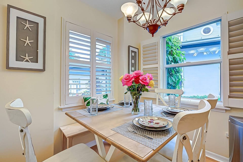 Dining table for 6, 4 chairs and a bench for 2.  Located right off the kitchen for easy cleanup.