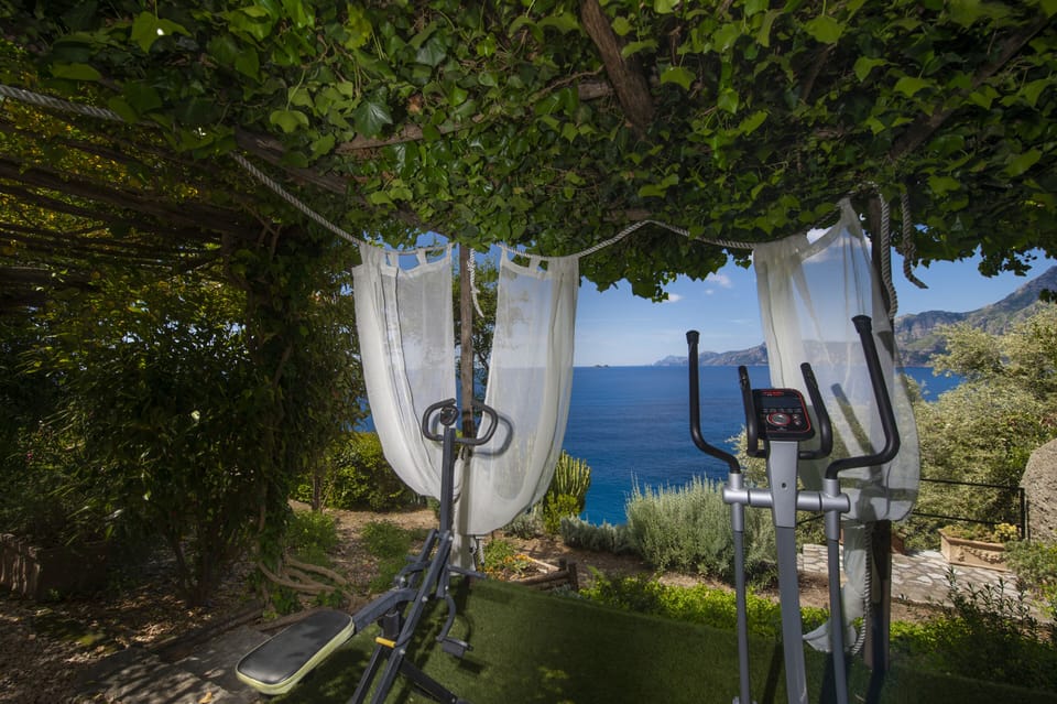 Outdoor exercise area: free weights, treadmill, elliptical machine.