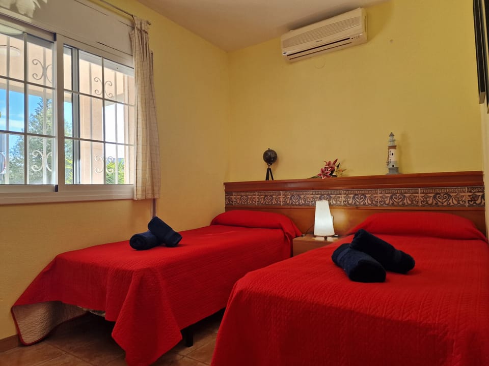 Plenty of space for the whole family: The third bedroom at House Angeles also features two twin beds and its own air conditioning.