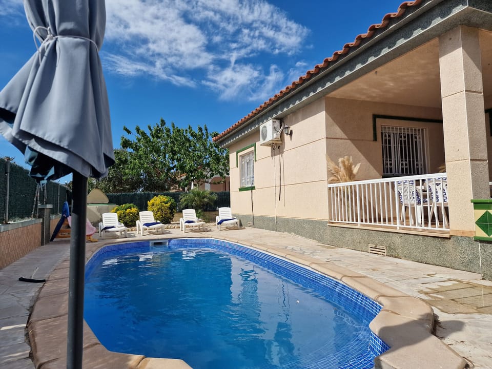 Another look at the outdoor area: This perspective highlights the spaciousness of the terrace and the pool's perfect location at House Angeles.
