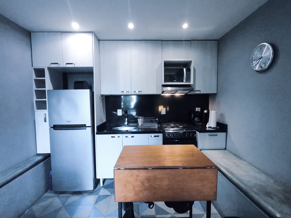 Kitchen with granite counter and backsplash, has microwave and stove. 
